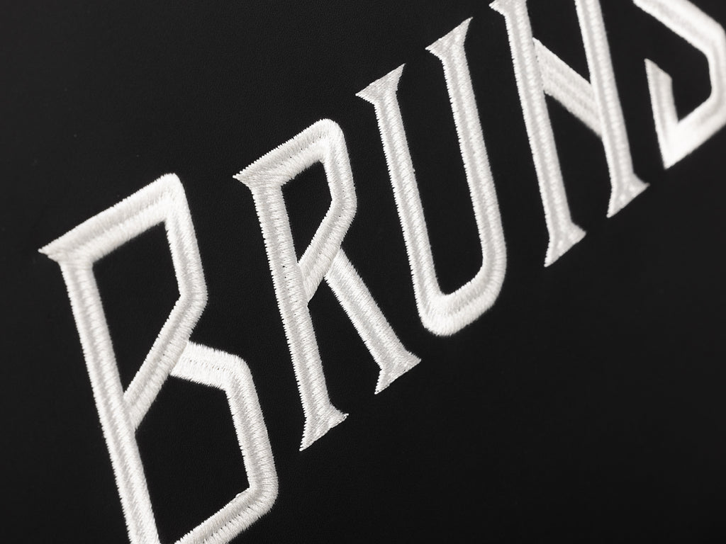 Brunswick embroidery in white on black chair pad