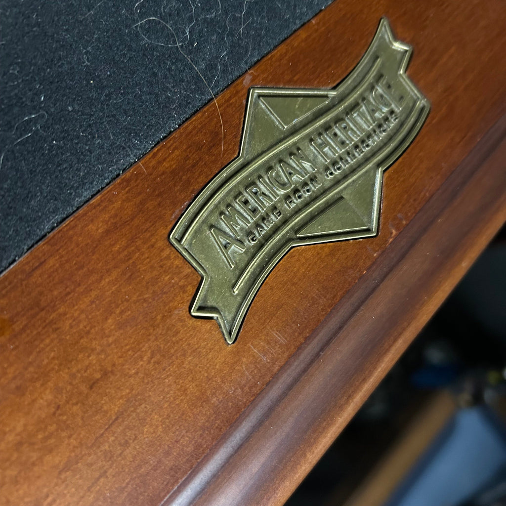 American Heritage logo on end rail of pool table