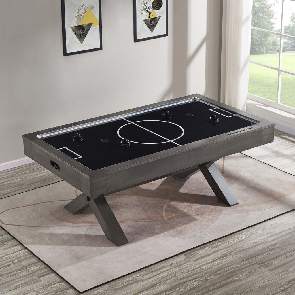 overhead shot of air hockey table with black playfield and white lines