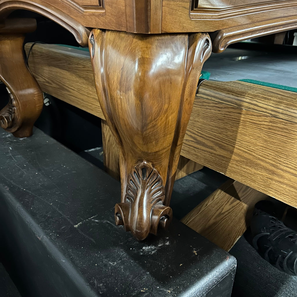 Closeup of ram's horn leg in mahogany finish