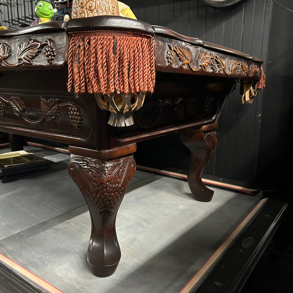 Corner view from right side of pool table with queen ann leg and carved details