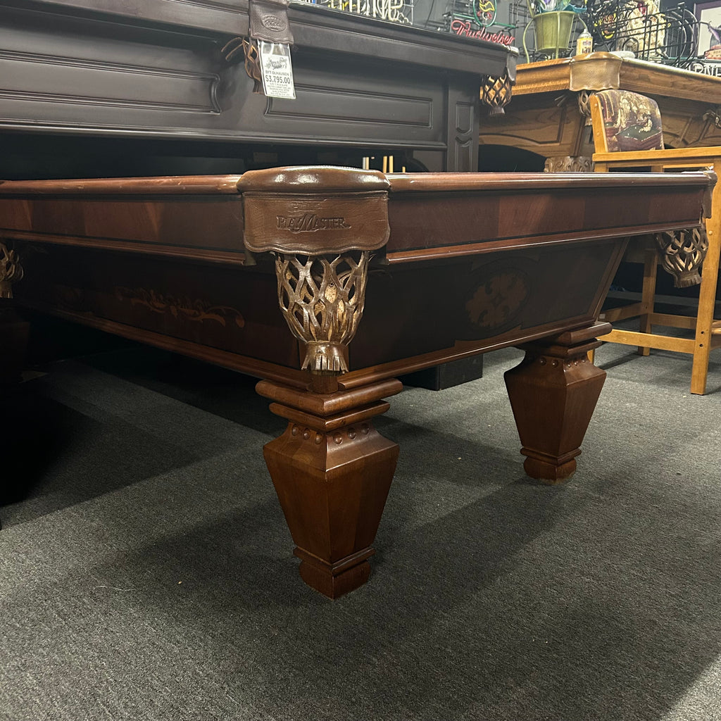 Overall view from left side of pool table with design on cabinet