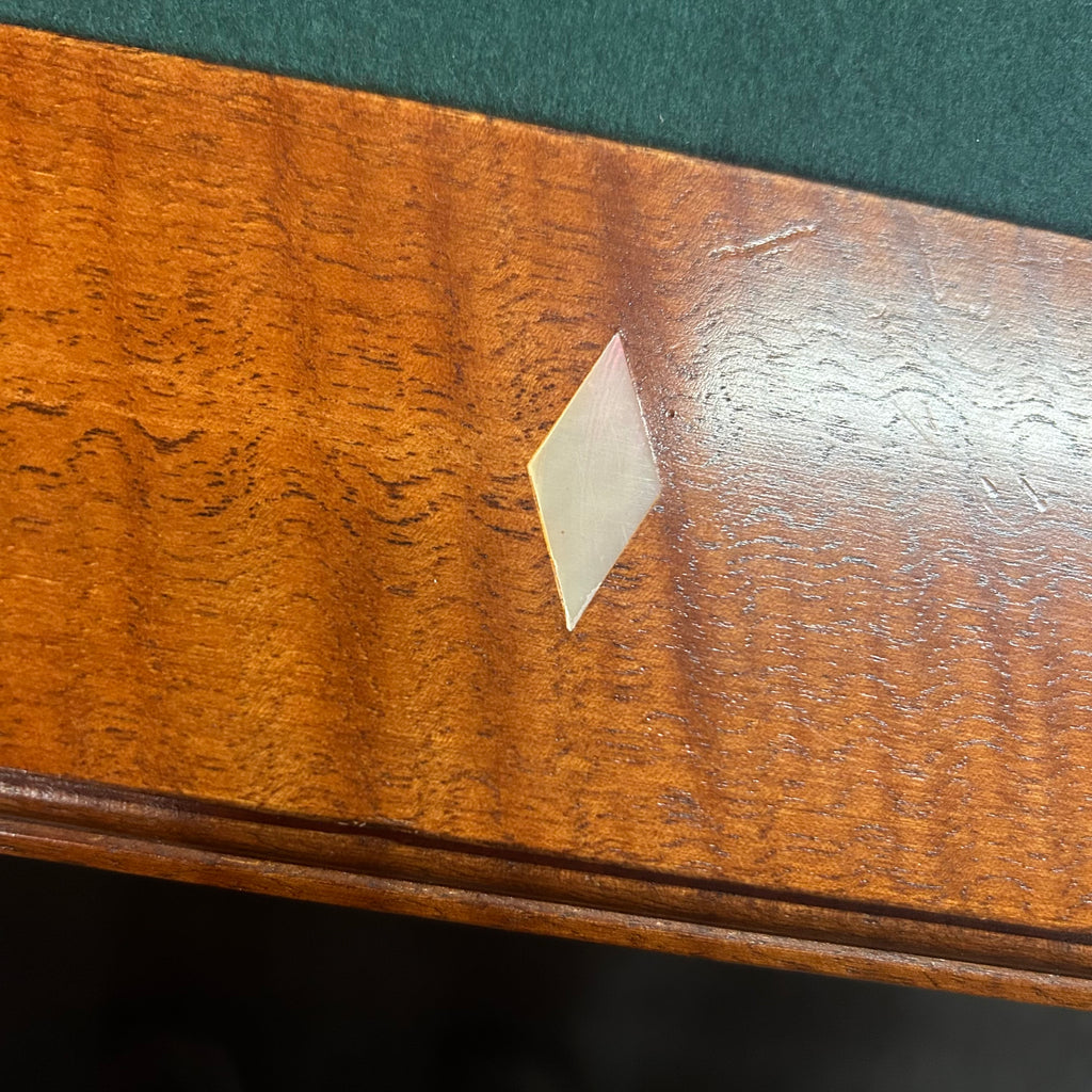Diamond site on pool table rail with green cloth 