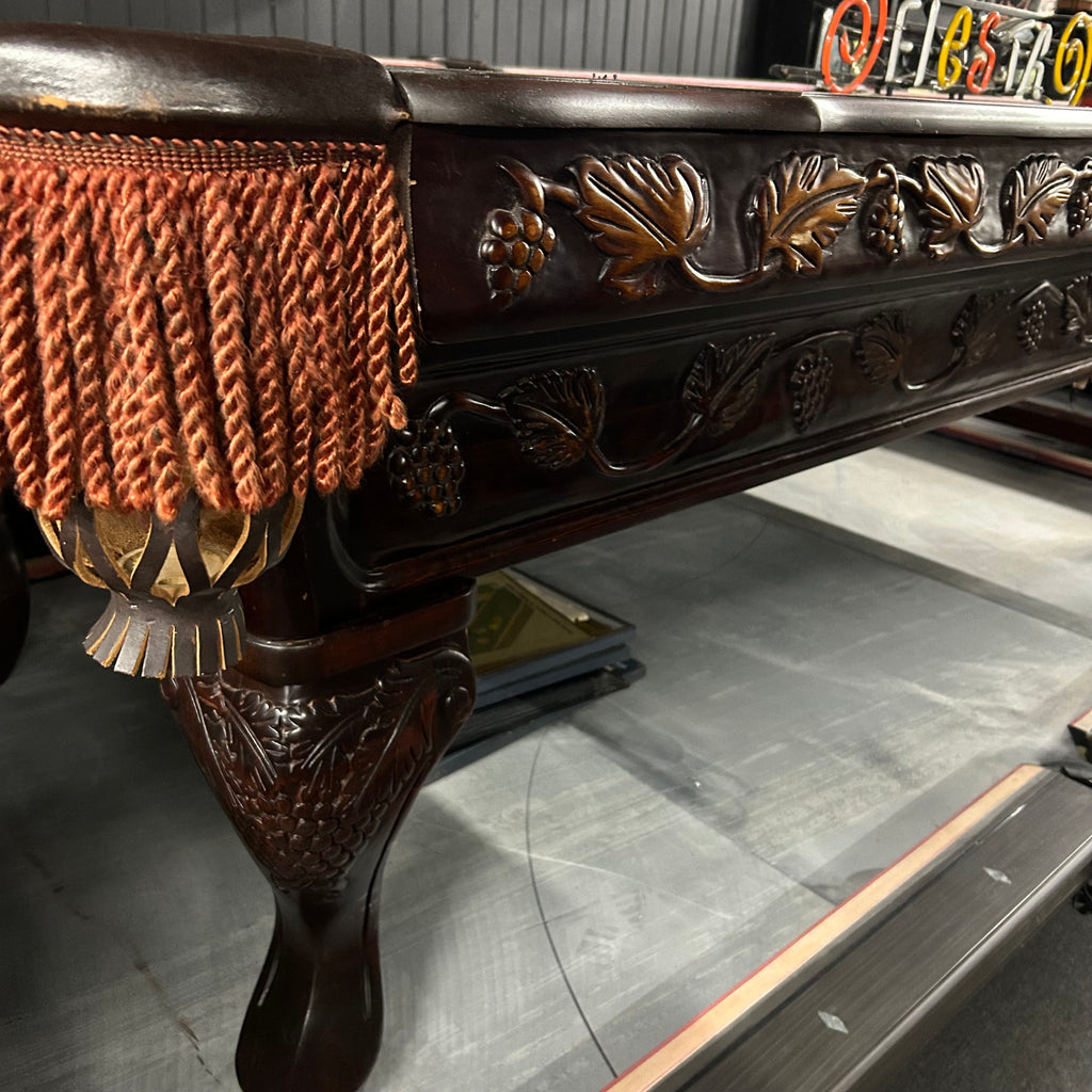 CLoseup of carved pool table cabinet details and leg