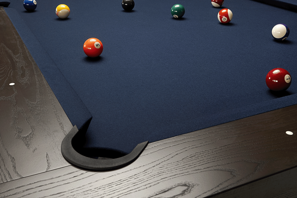 View of pool table surface showing navy felt and drop plastic pocket