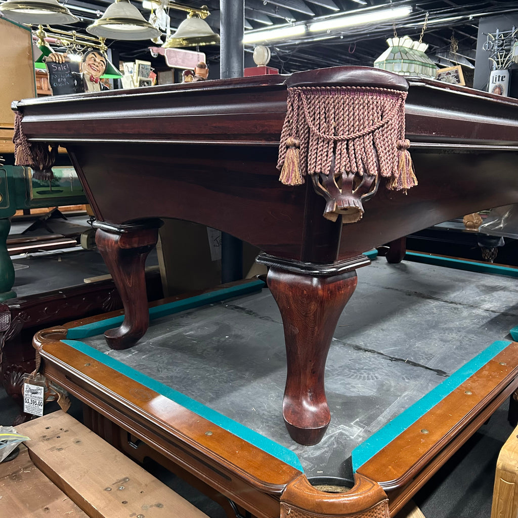 Corner view of pool table with queen ann leg in mahogany finish and tassel fringe pocket