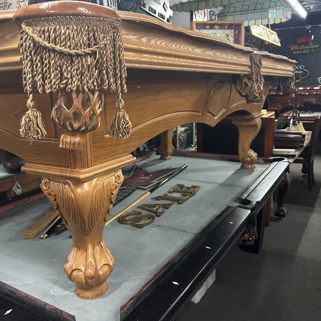 side view of pool table with tassel fringe pocket with arched cabinet 
