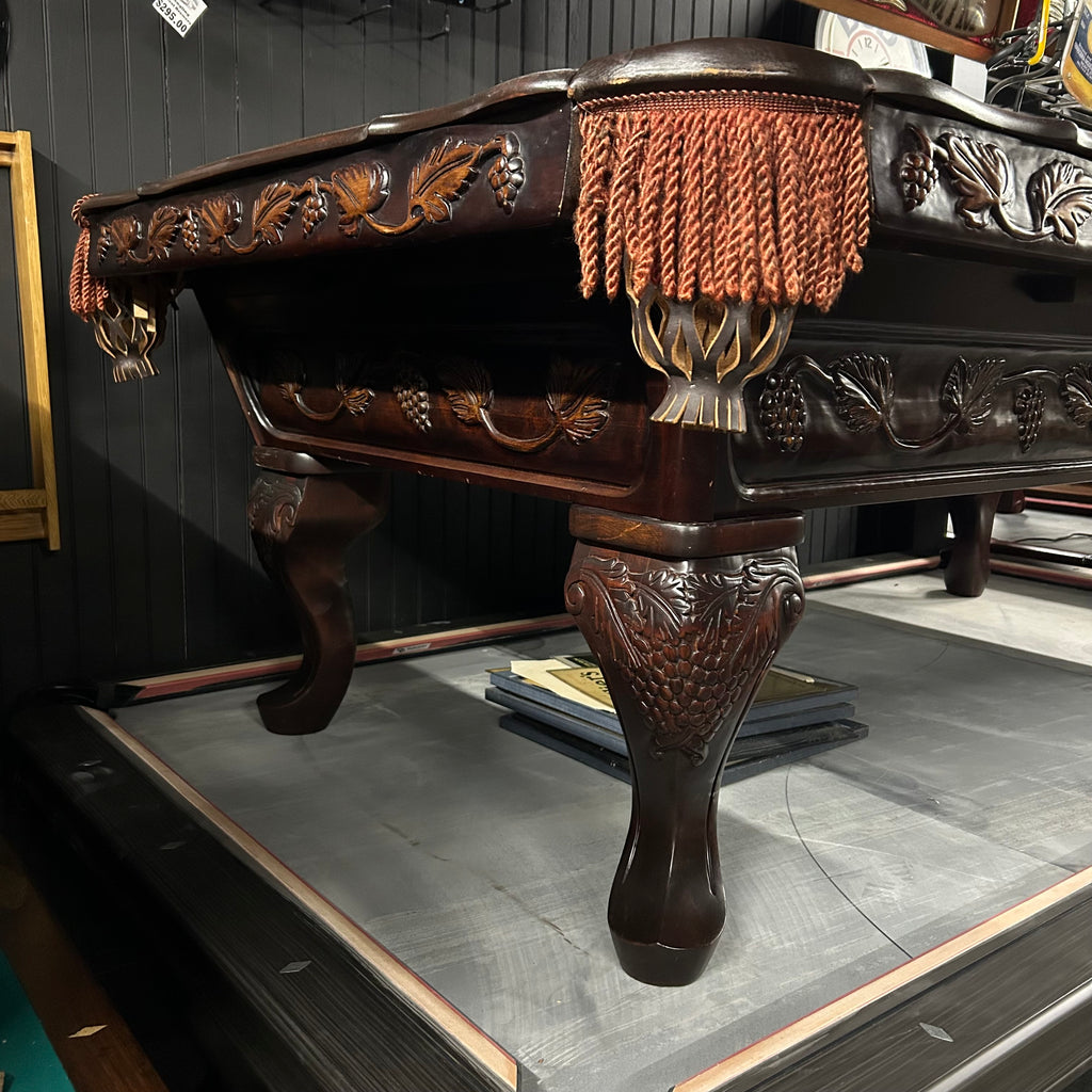 Corner view from left side of pool table with queen ann leg and carved details