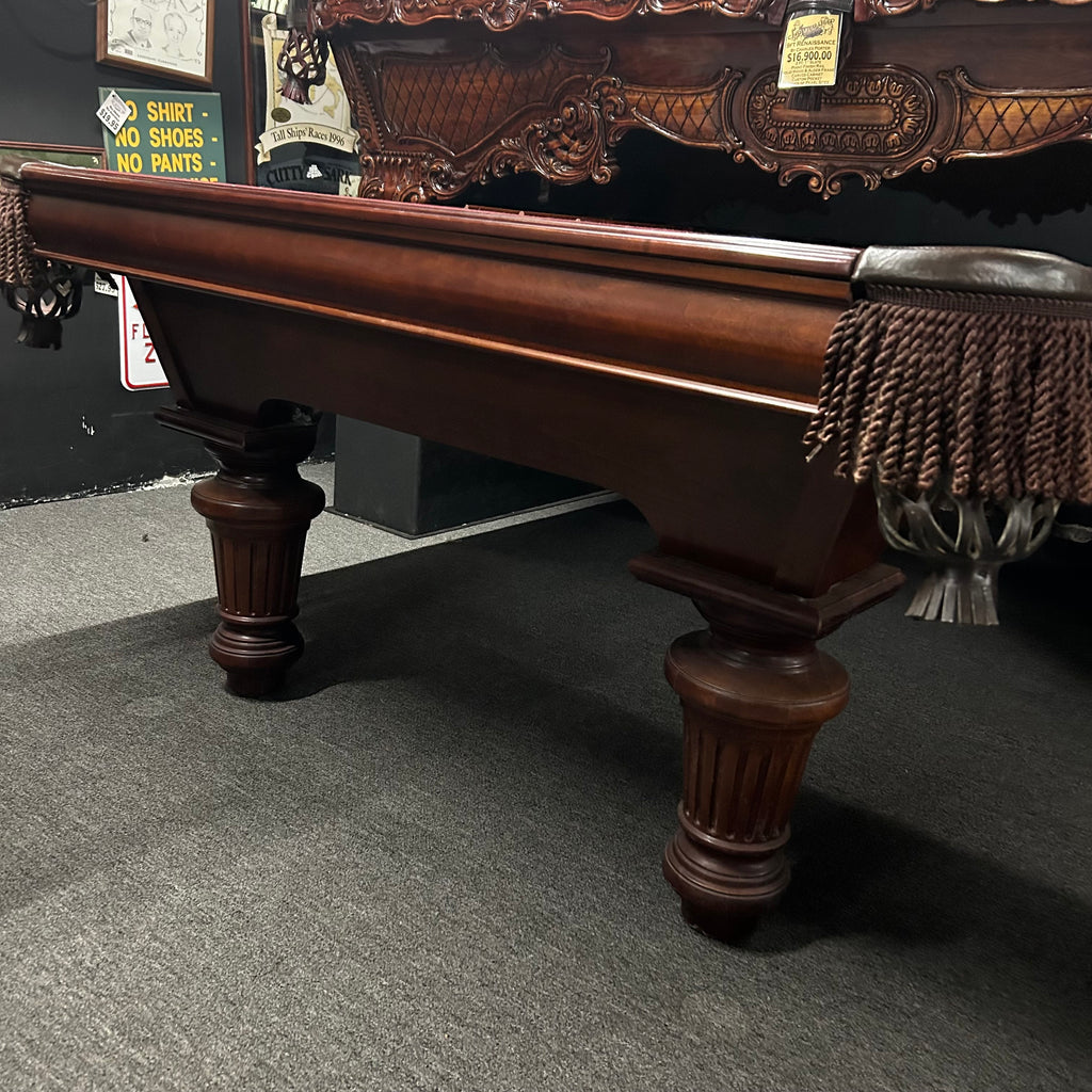 End view of pool table in mahogany finish with fringe pocket and round leg 