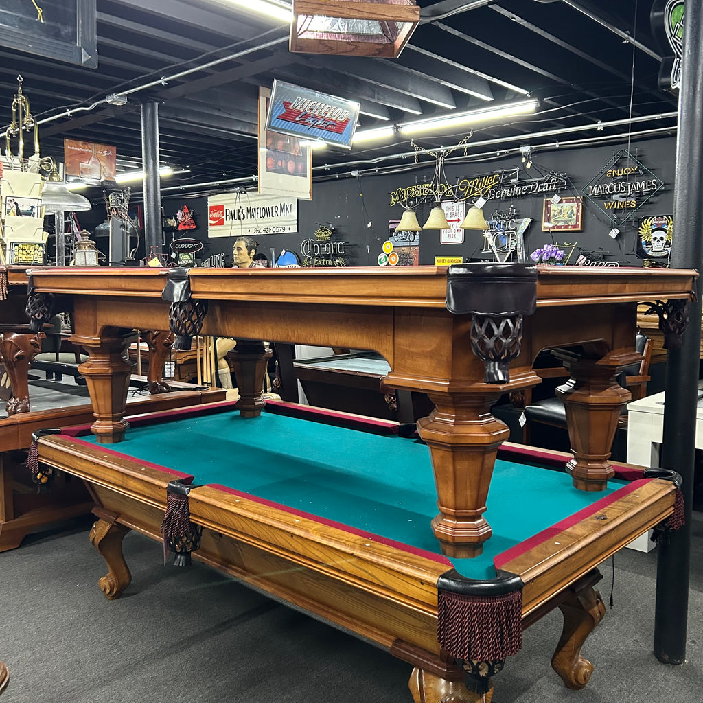 Maple pool table with black shield pockets and round tapered legs from right side