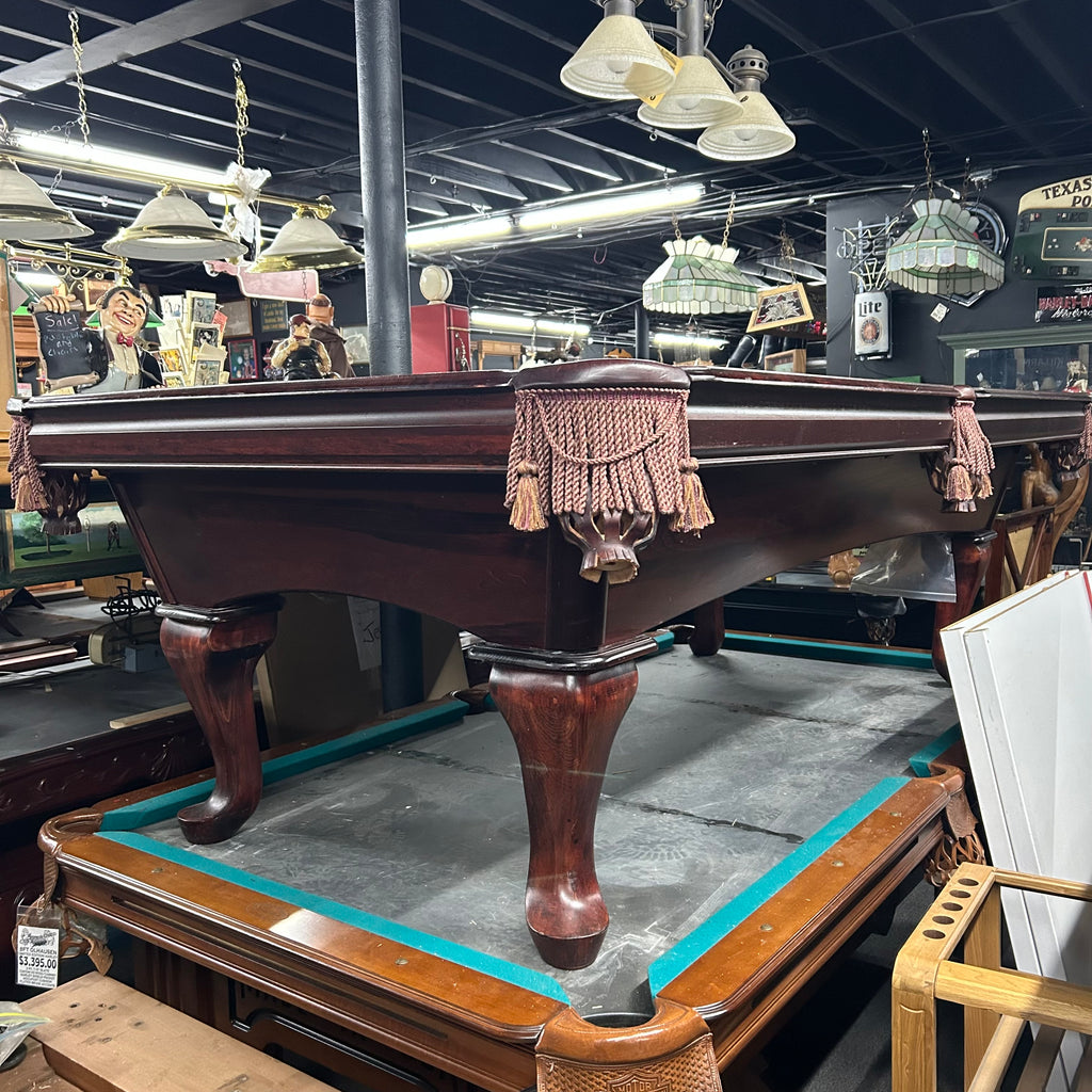Overall view of left side pool table with queen ann leg in mahogany finish and tassel fringe pocket
