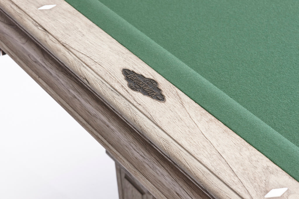 Closeup of rail with brunswick name plate and green felt