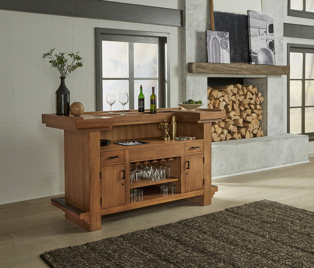 Alta home bar at  angle in room from back in walnut finish with black footrail