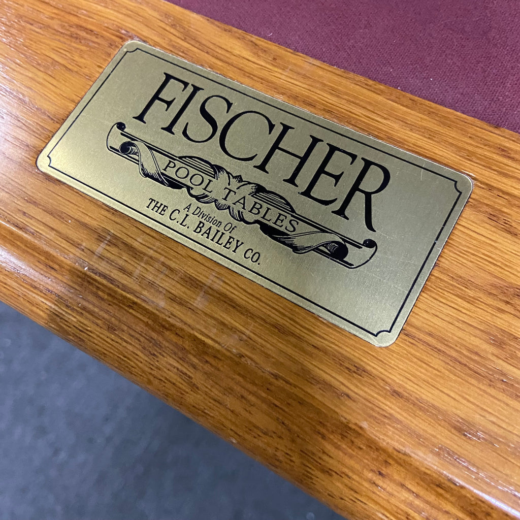 close up of pool table rail label that says fischer pool tables a division of cl bailey co