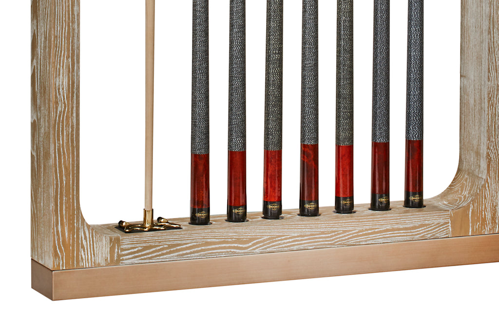 closeup of bottom of cues and bridge stick sitting in sandwashed wall rack
