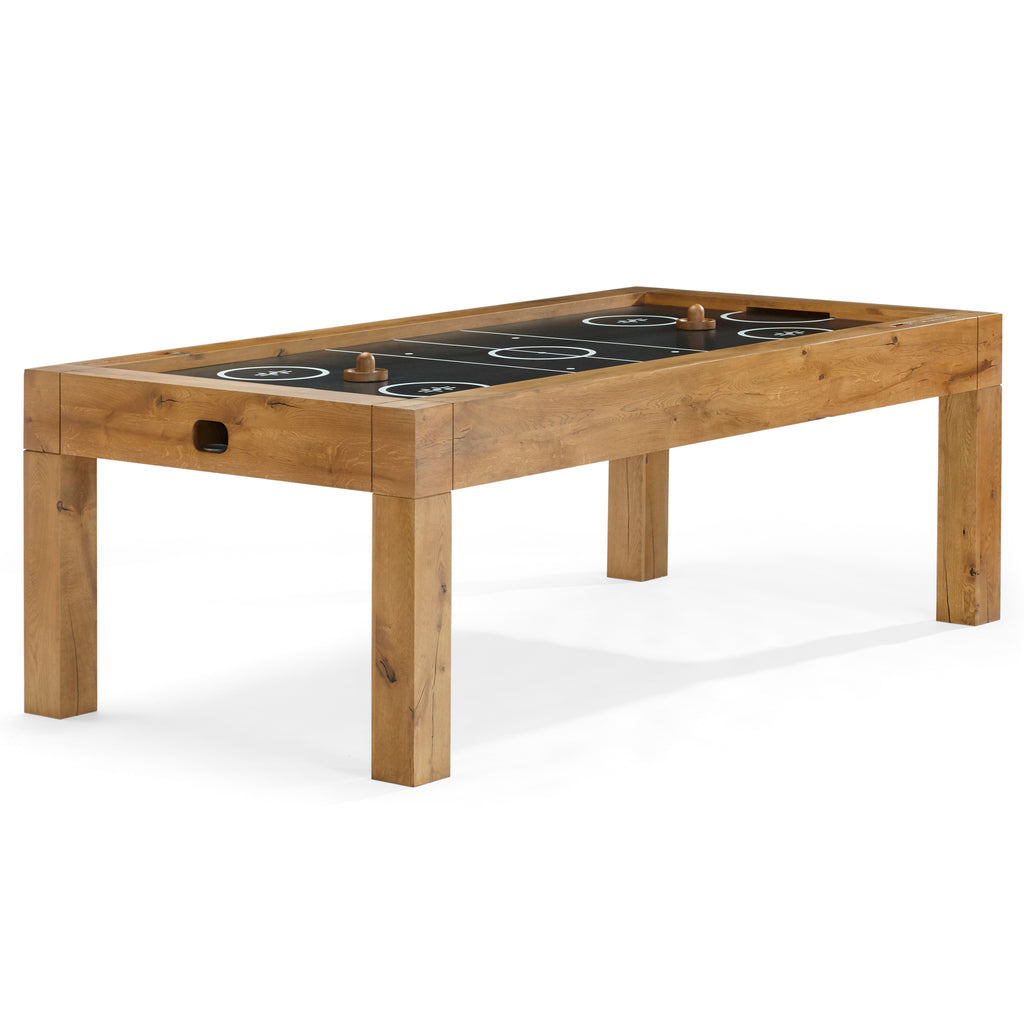 Parsons air hockey table with puck handles on top of it