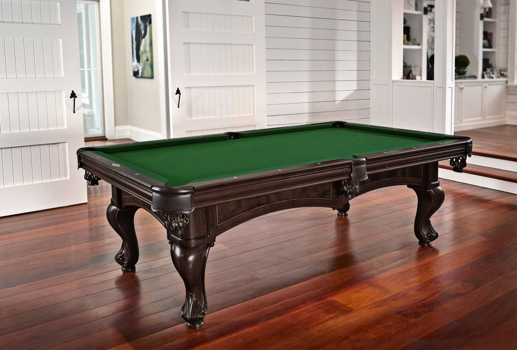 dark colored brown pool table with leather shield pocket and green cloth