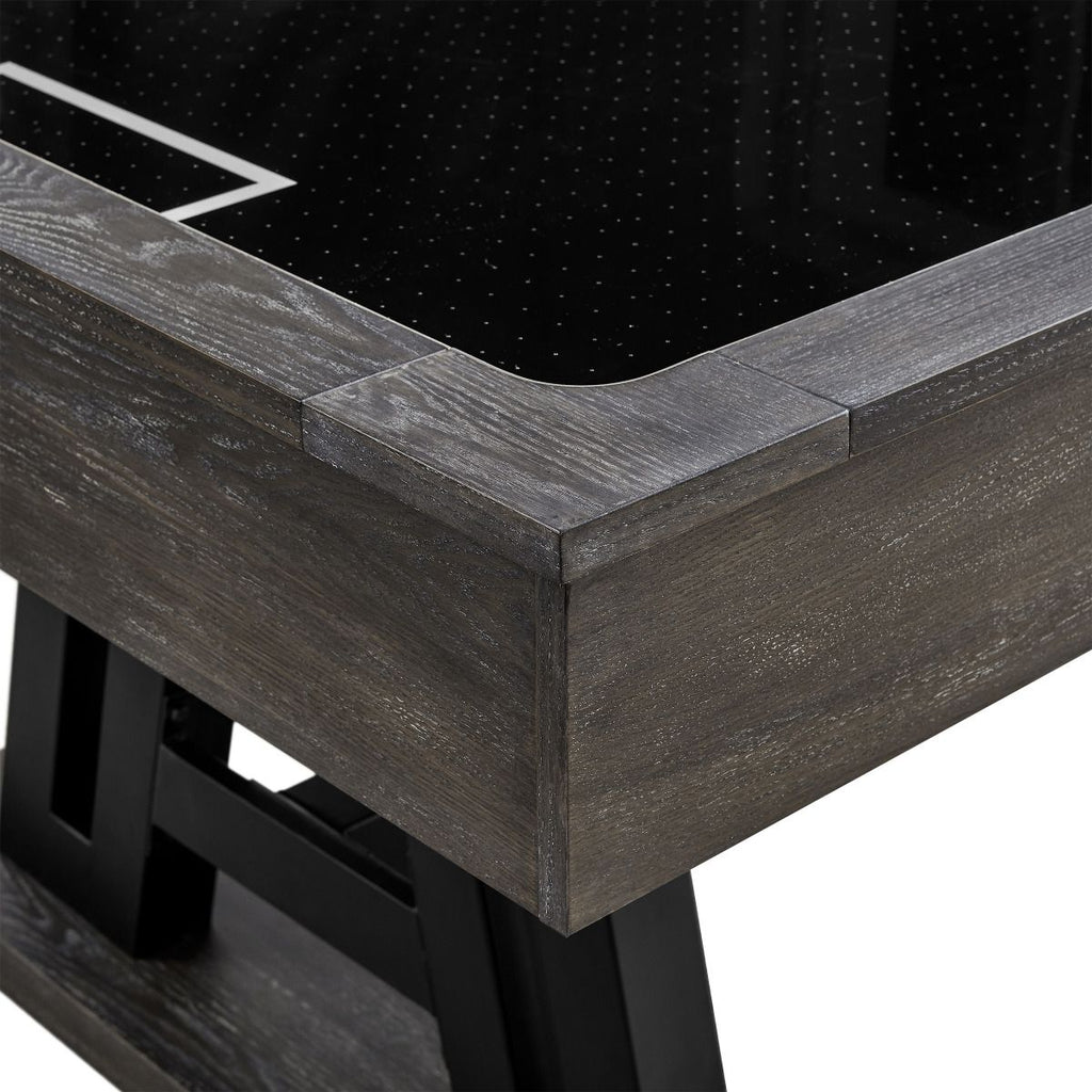 Gray finish corner of air hockey table showing black playfield