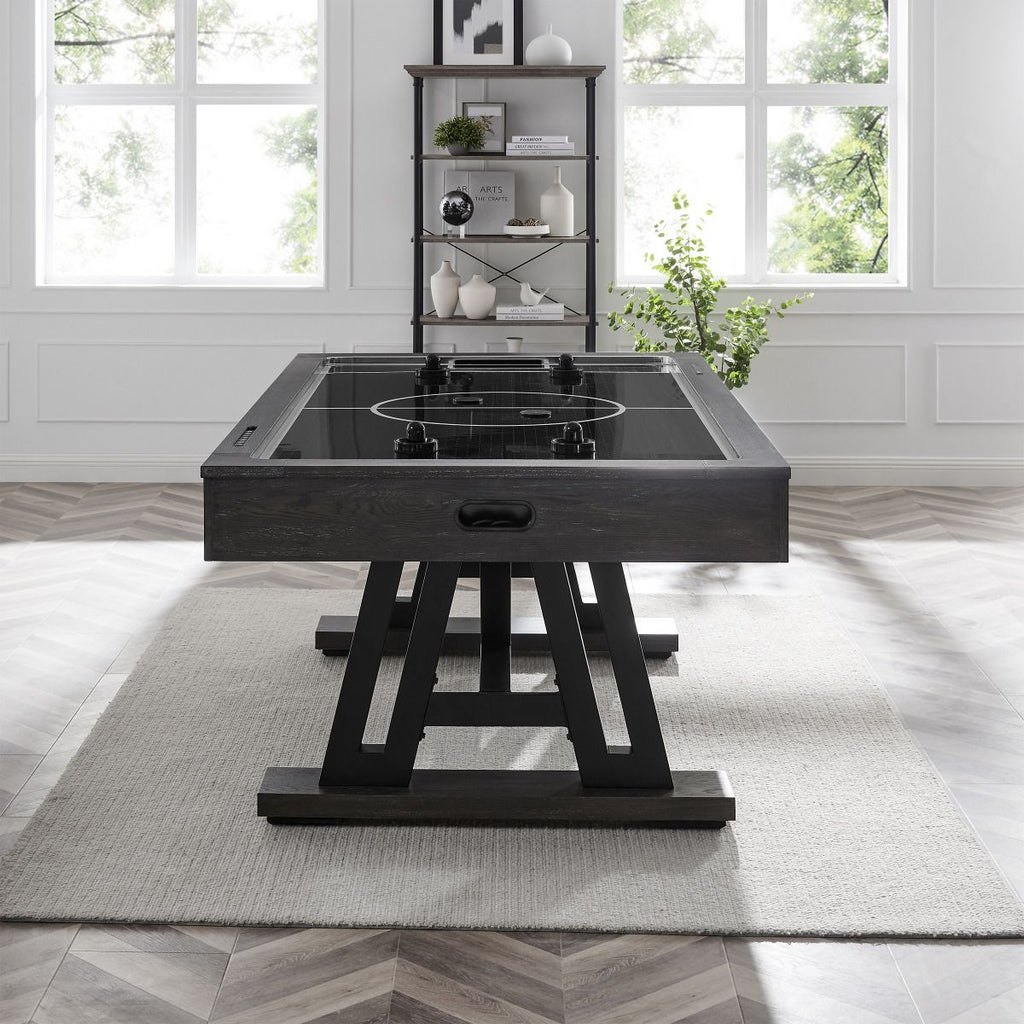 white rug and gray air hockey table with black playfield