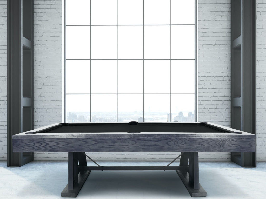 Amber pool table in loft in front of window