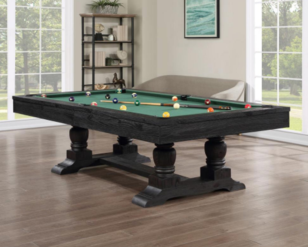 Pool table in a room with large windows and a bookshelf.