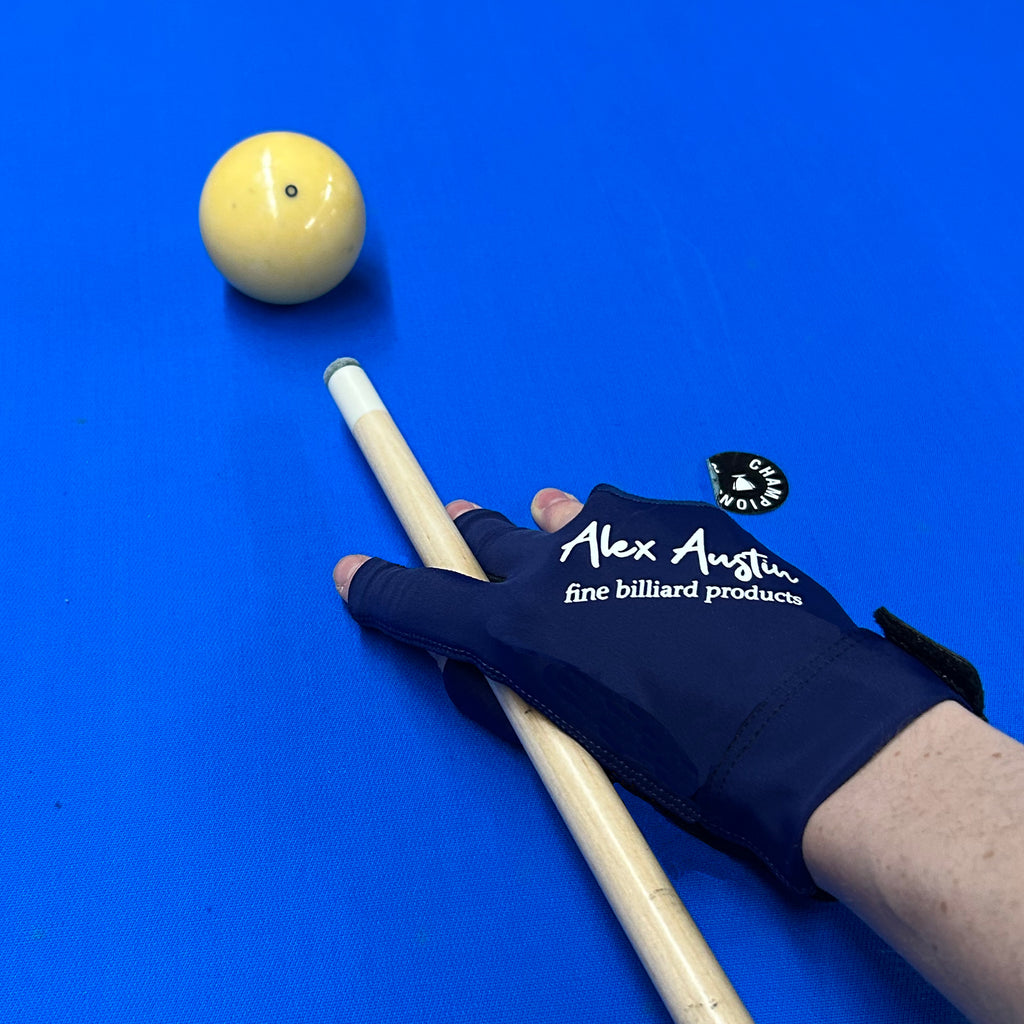 Dark Blue and black glove three fingered billiards on pool table with light blue felt