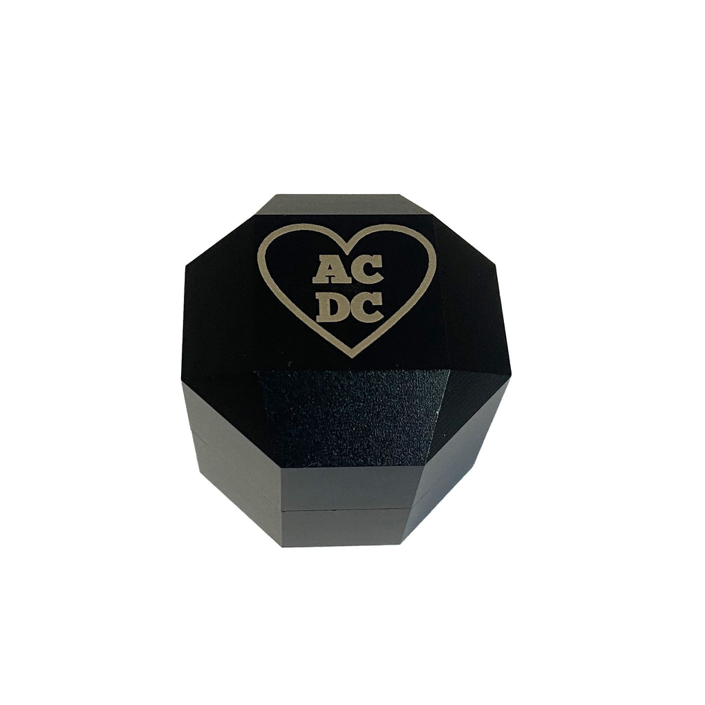 black aluminum chalk holder closed with heart and AC DC on lid in block font
