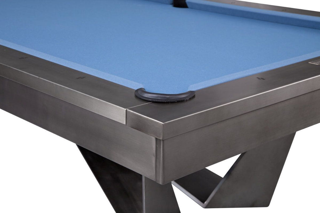 Corner view of metal pool table with black pocket rim 