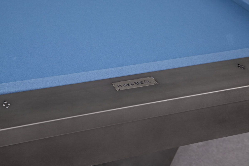Plank and hide logo on end rail of pool table with blue felt
