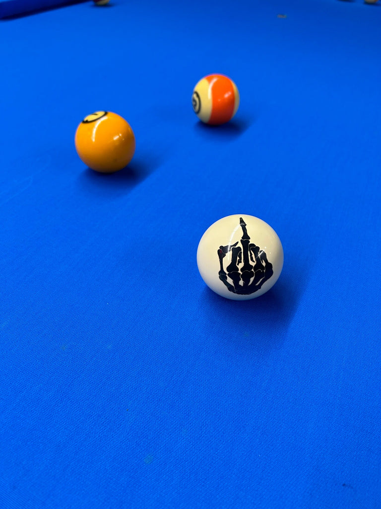 finger cue ball on bue felt pool table with balls 