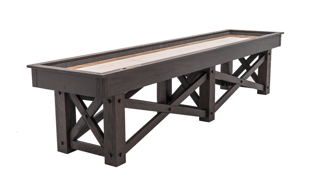 Angled top view McCormick shuffleboard showing criss crossed leg baseOtis shuffleboard table inweathered grey finish with metal stretchers and three criss cross pedestal base legs