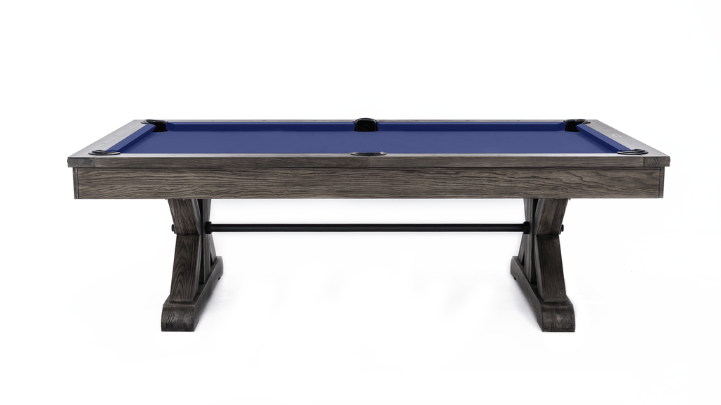 Side view of weathered grey pool table with steel bar stretcher and purplish blue cloth