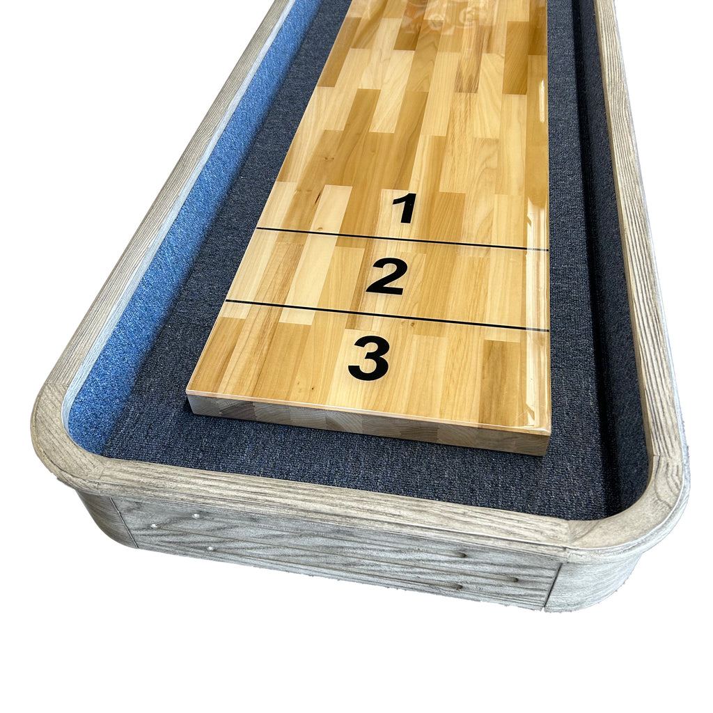 Gray shuffleboard with playfield showing butcher block style and blue carpet lining
