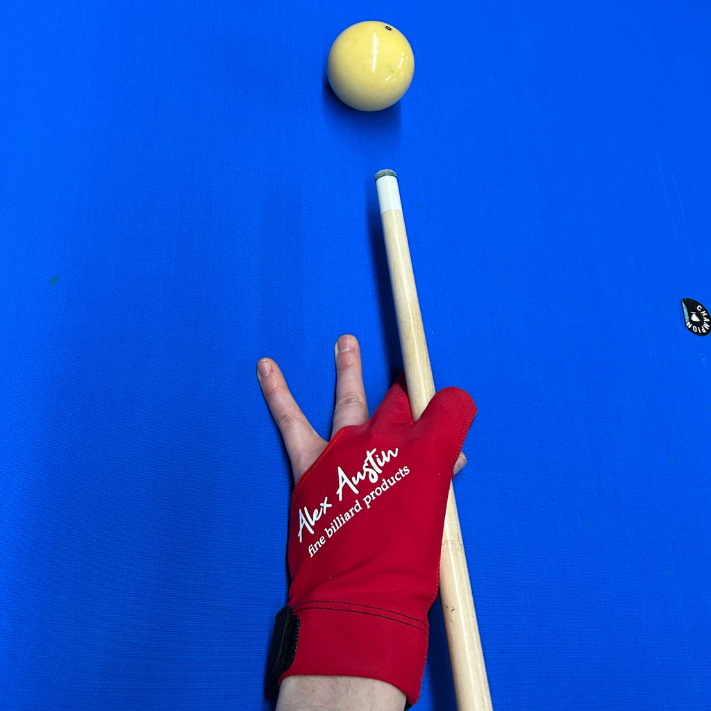 Red and black glove on blue pool table holding cue with alex austin logo on it