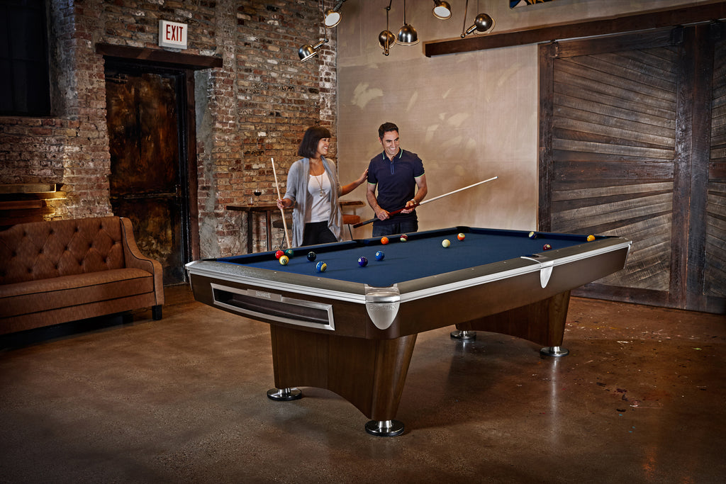 Gold Crown VI Pool Table in room with balls on table with people